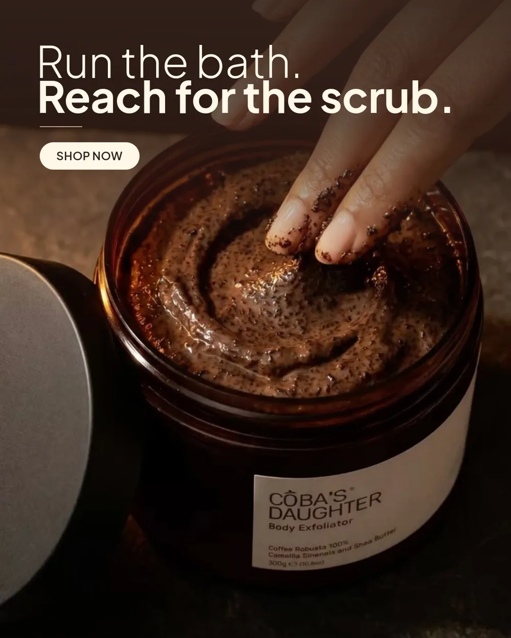 Fingers in an open jar of CoBa’s Daughter Robusta coffee scrub