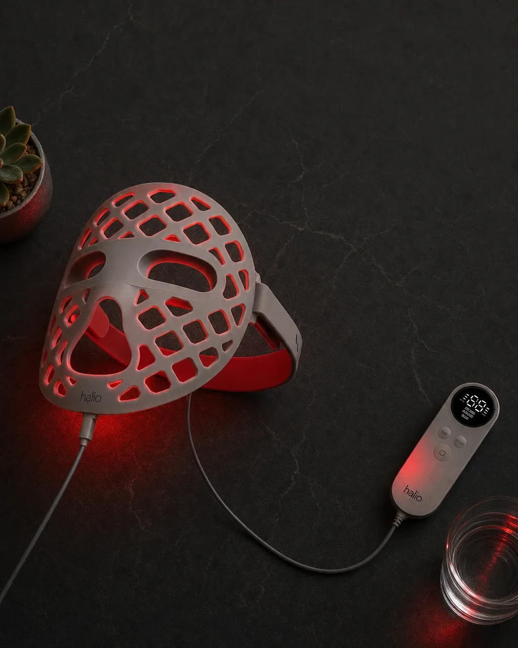 Halio PureGlow Ultralite Silicone LED Face Mask Pro, dark flatlay glowing mask two line headline roun