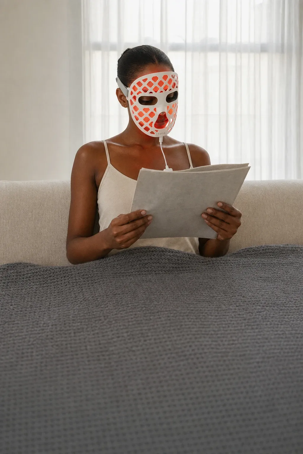 Halio PureGlow Ultralite Silicone LED Face Mask, window backlit couch reader side wordmark white