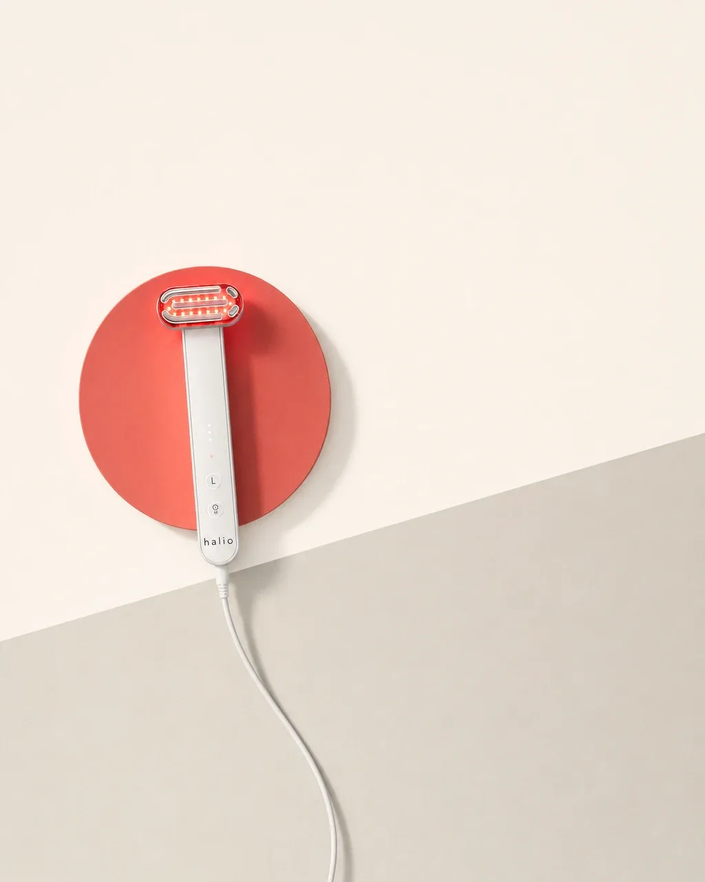 Halio Red Light Therapy Device, pastel diagonal split overhead flatlay disc two