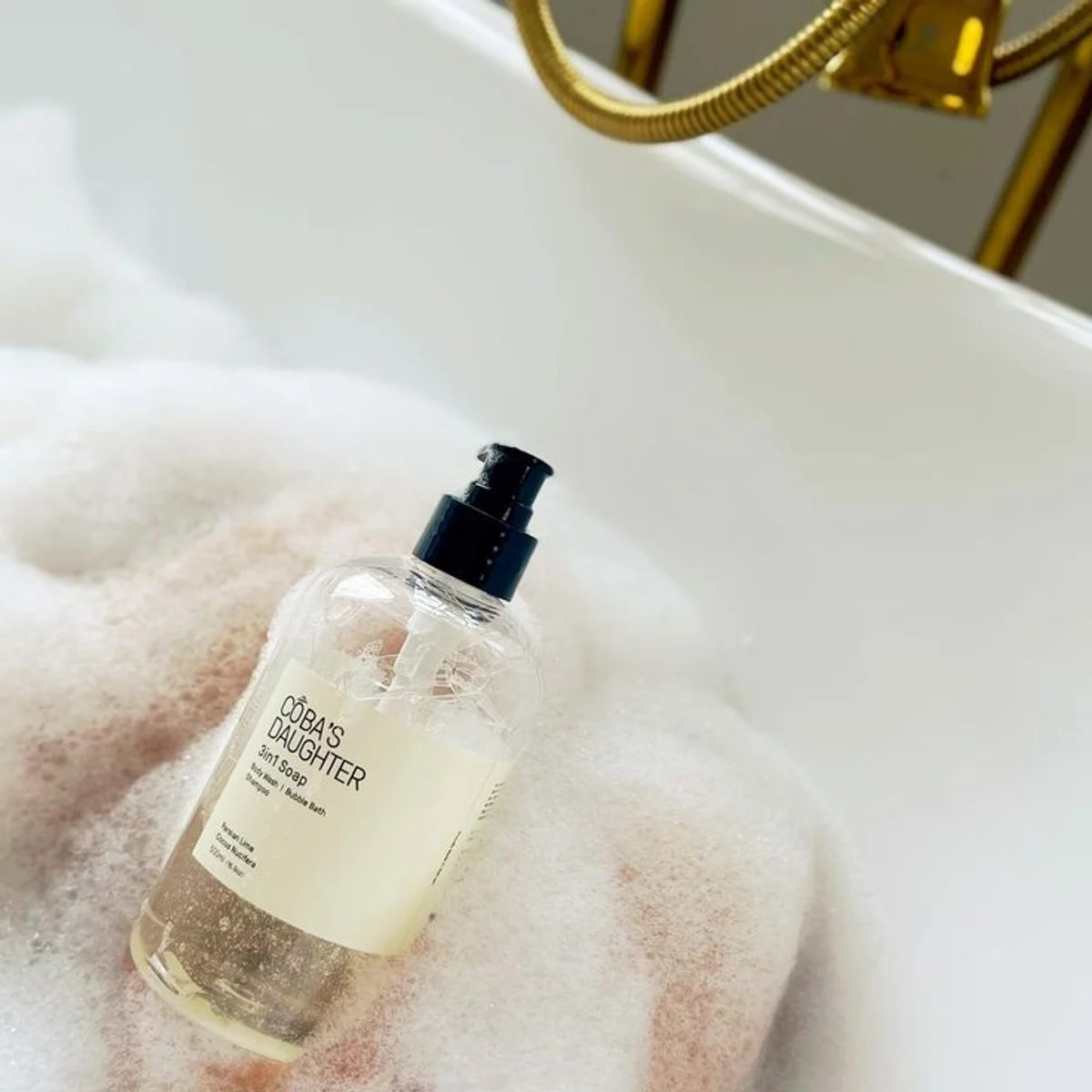 The 3in1 Soap resting in the foam of a running bath